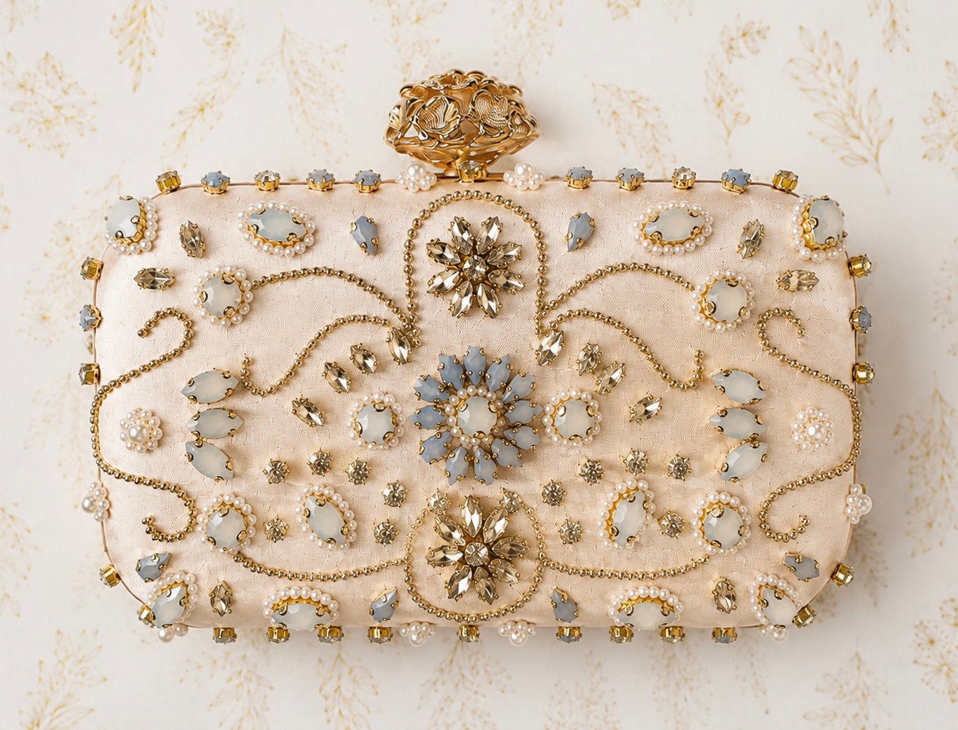 Decorative clutch bag with gold and blue embellishments on a light background